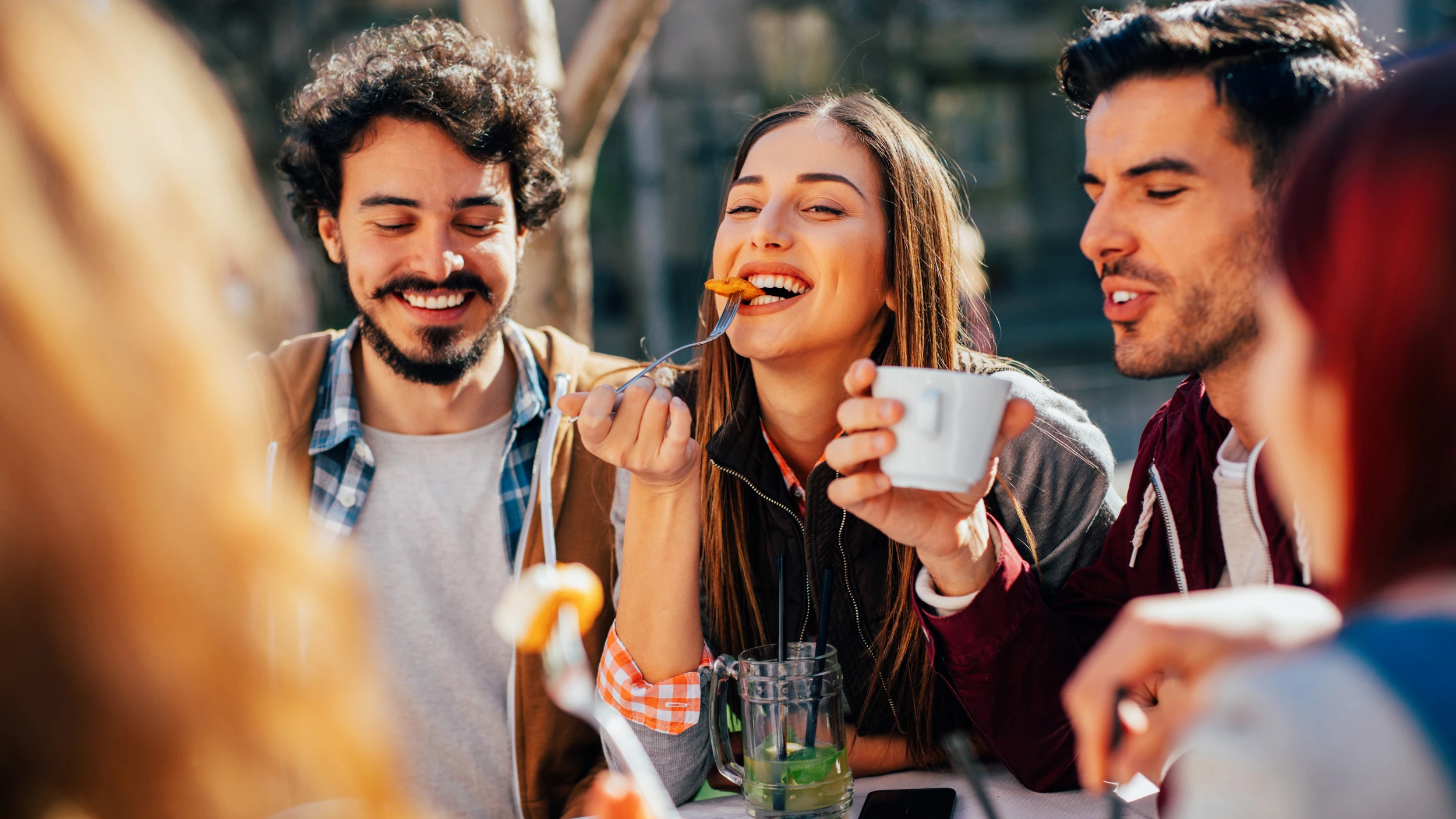 Women being comfortable eating socially at a restaurant