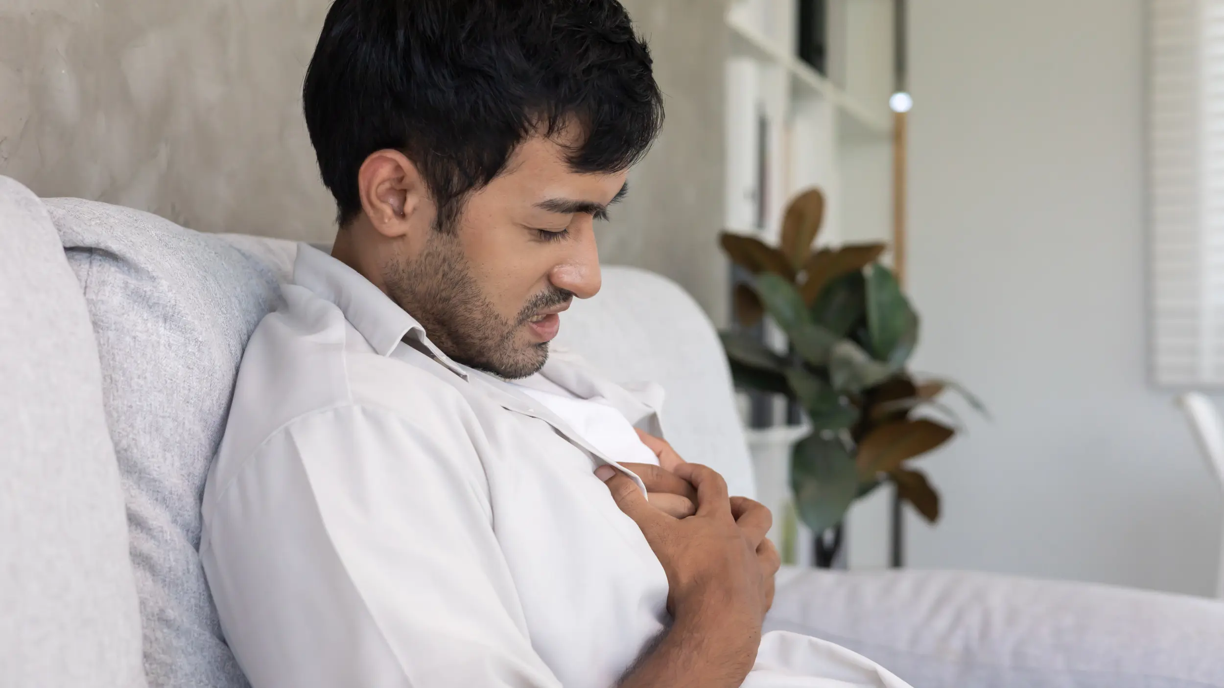 Man with acid reflux after a meal