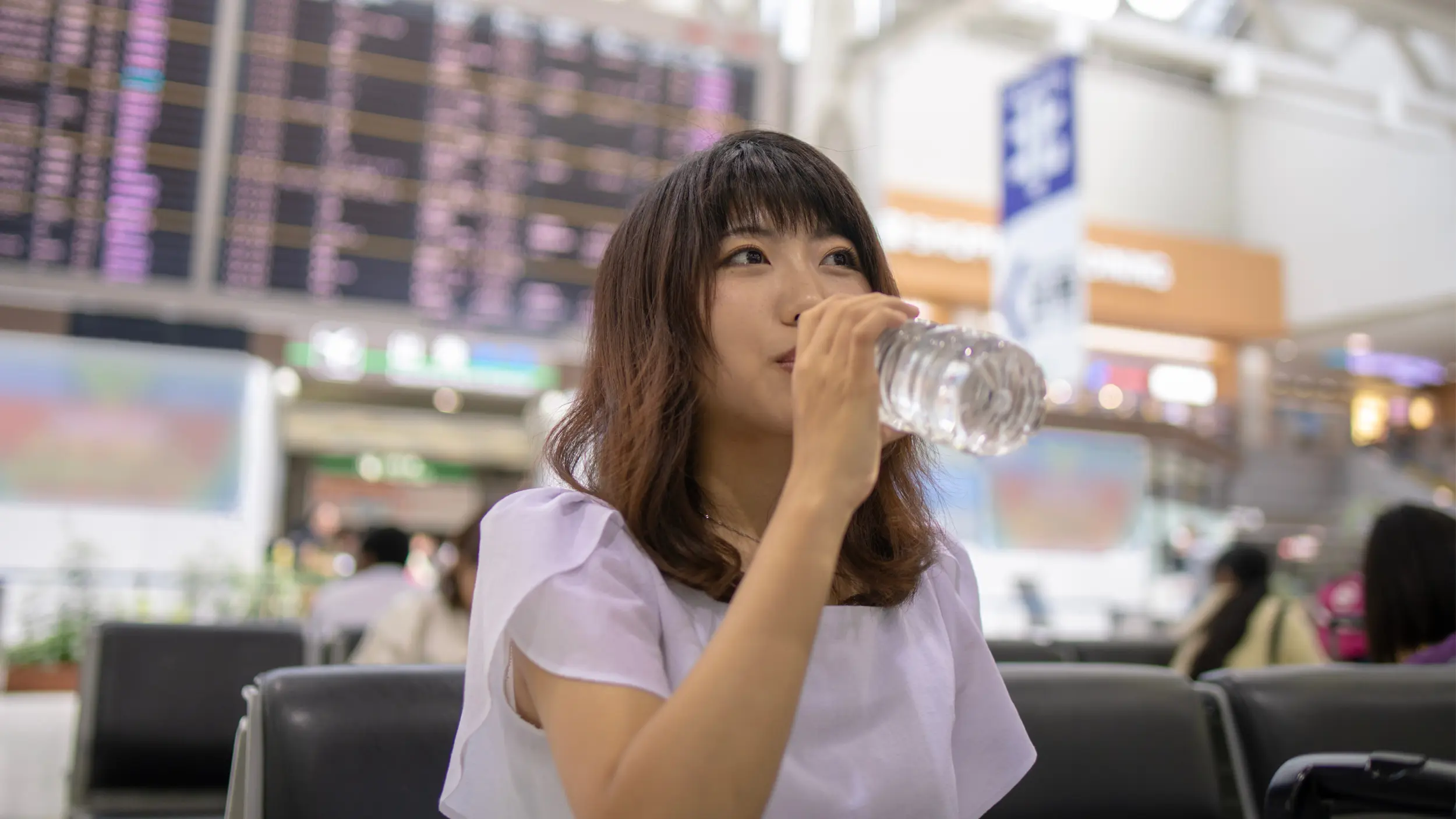Woman in the airport drinking water