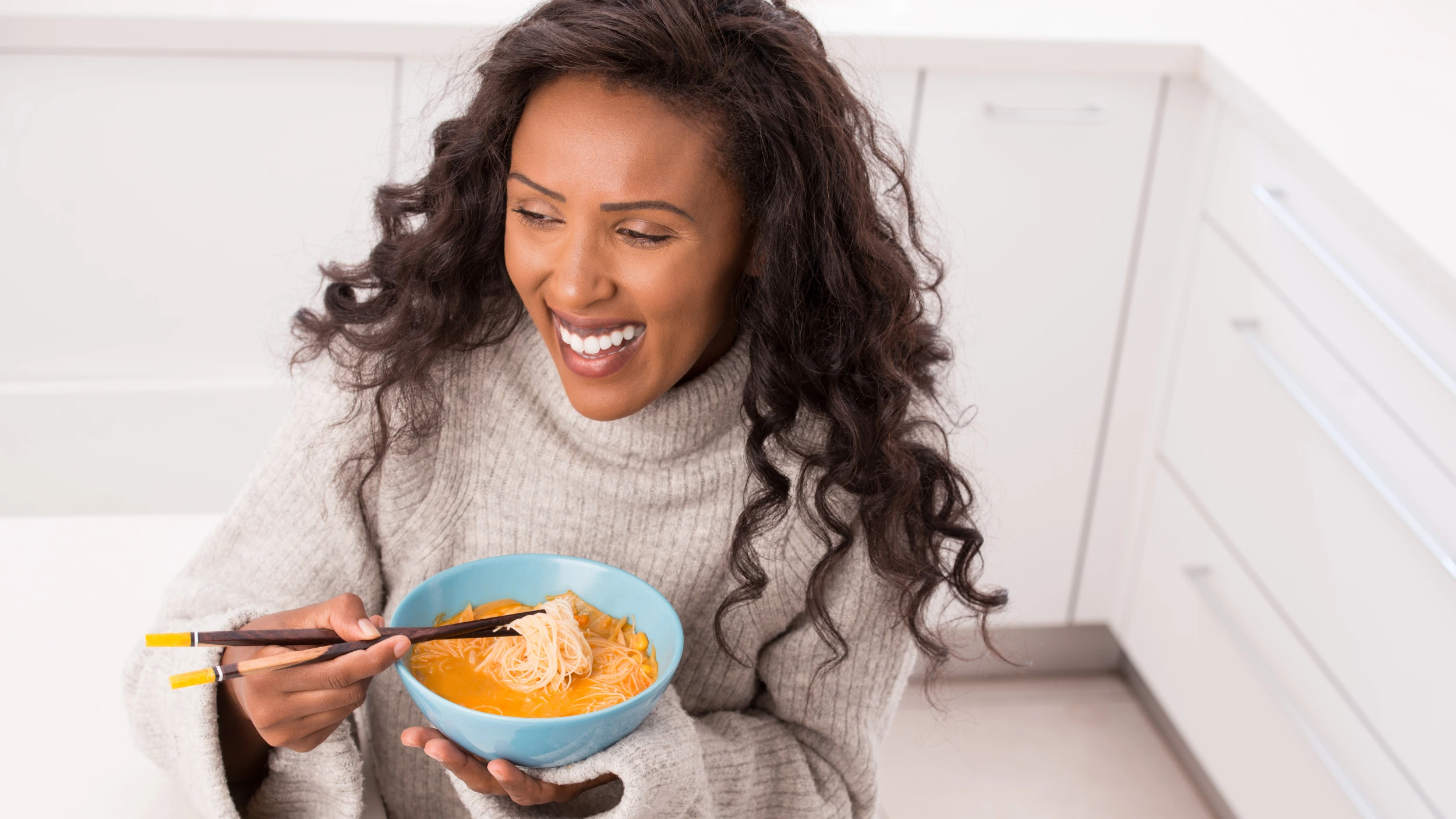 Woman eating soup for digestive discomfort on GLP1