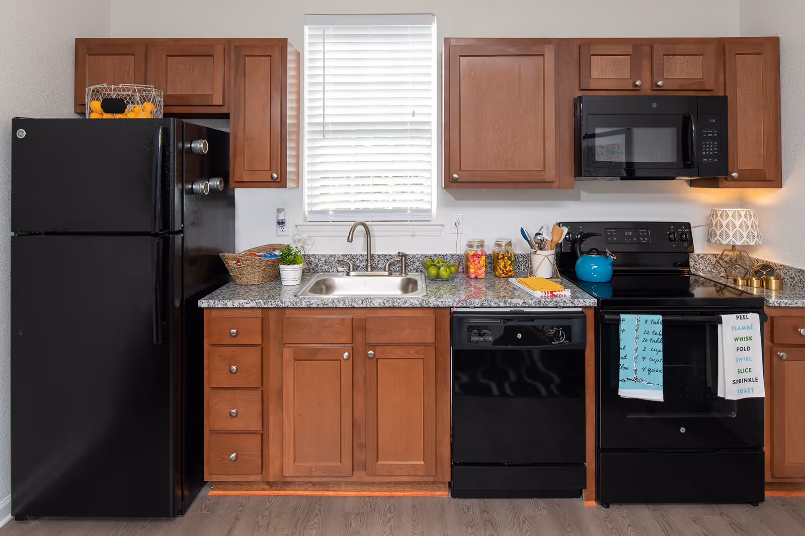 Kitchen with black appliances and brown cabinets