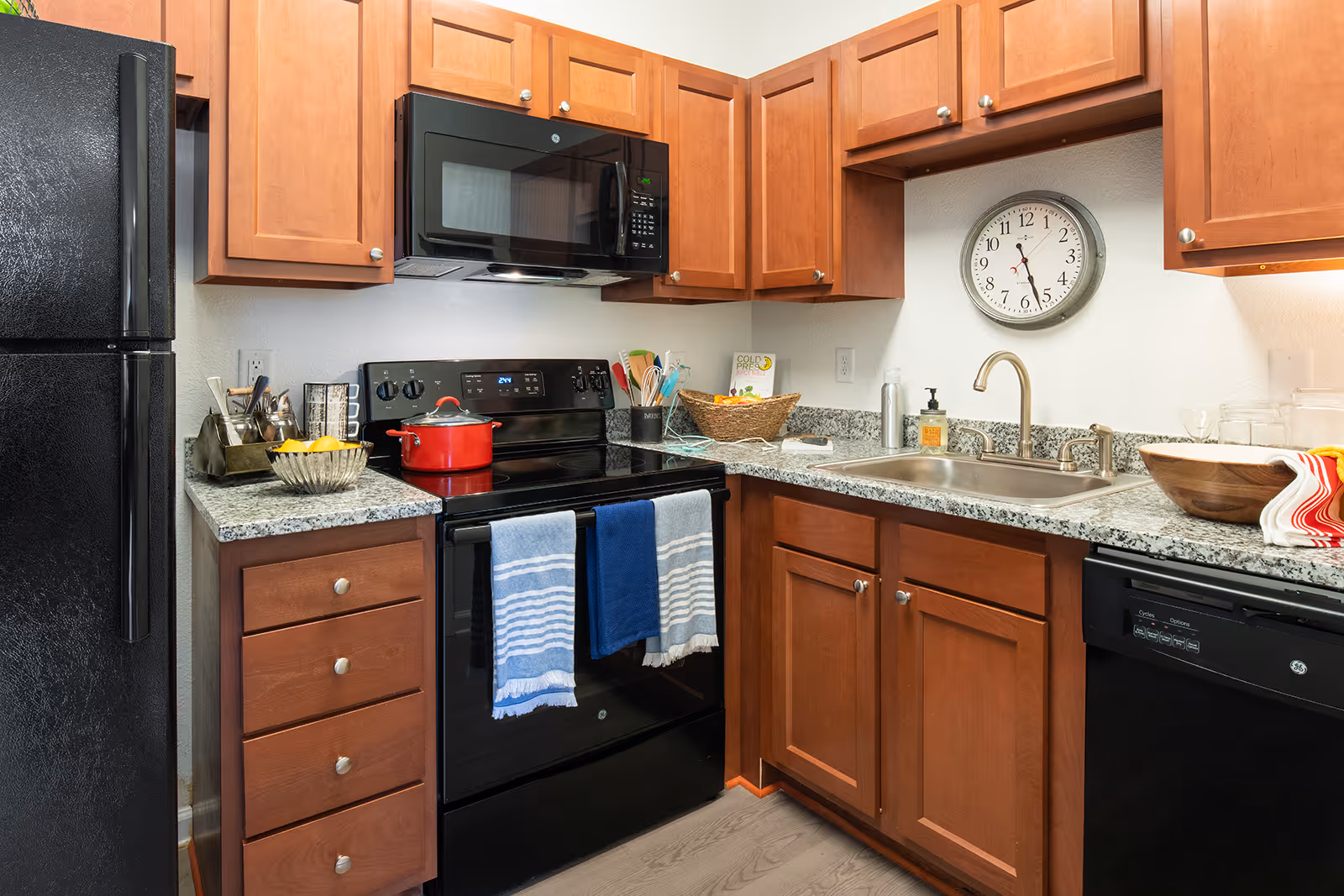 Kitchen with black appliances and brown cabinets