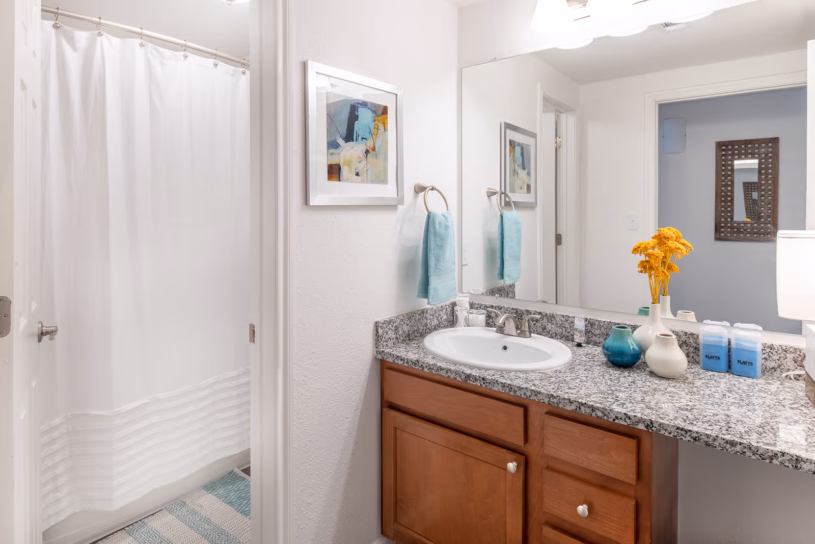 Bathroom with brown cabinets and how tub combo with vanity