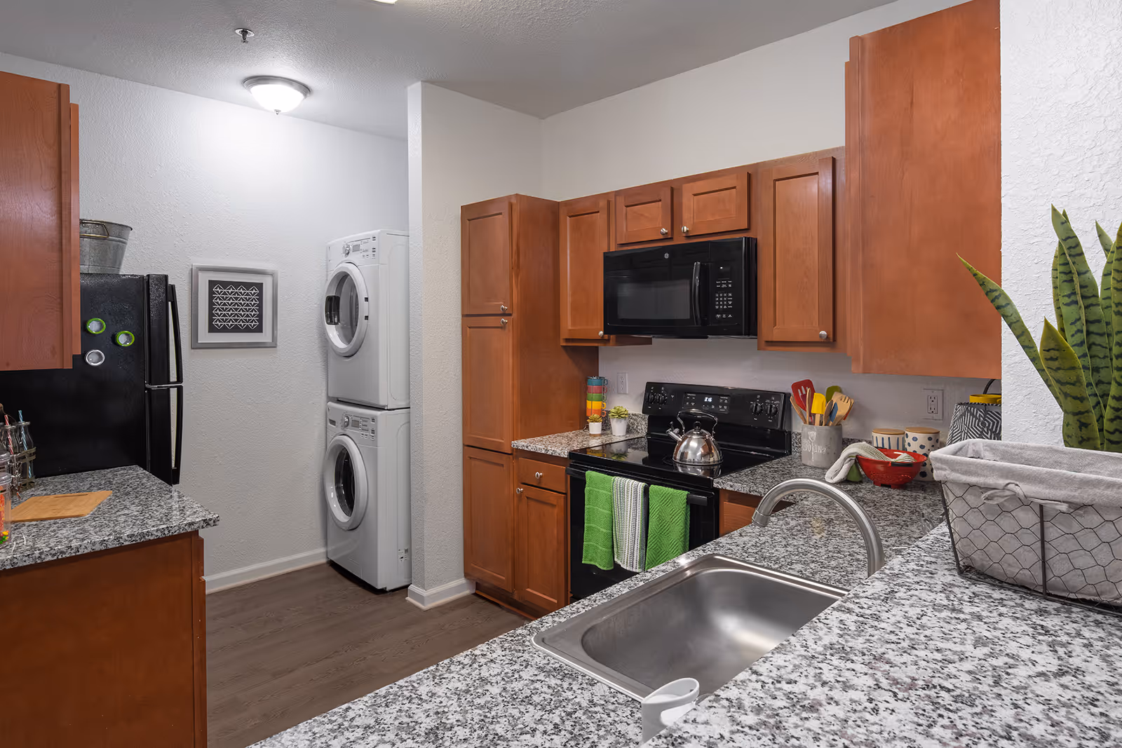 Kitchen with black appliances and brown cabinets