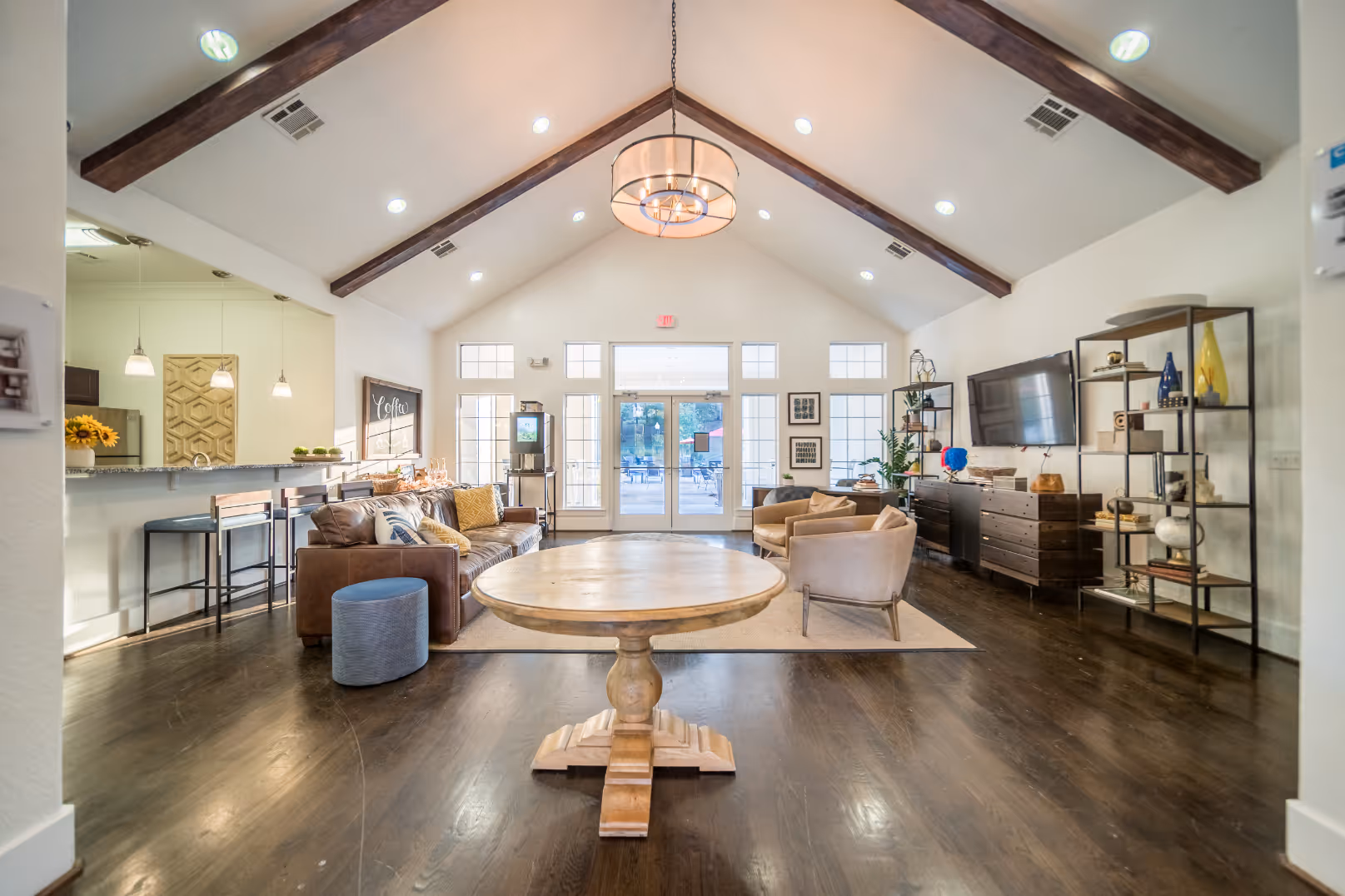 Clubhouse featuring sofas, coffee table, tv, and kitchen