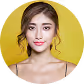 Portrait of a young woman with long dark hair, wearing a white off-shoulder top, against a yellow background.