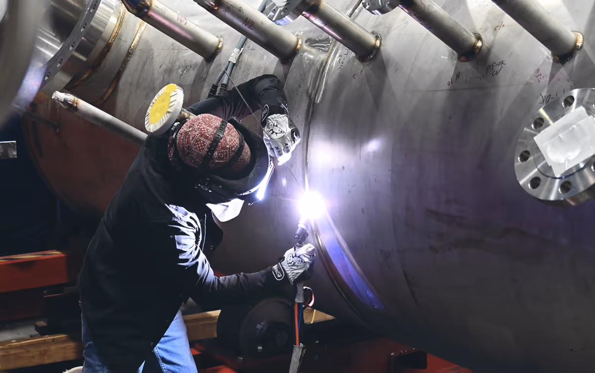 Worker welding vessel