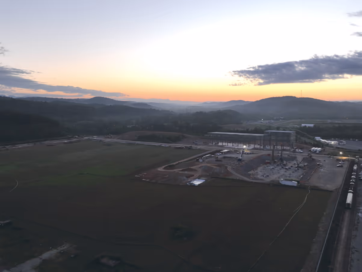 Late evening view of large installation with sun going down on horizon