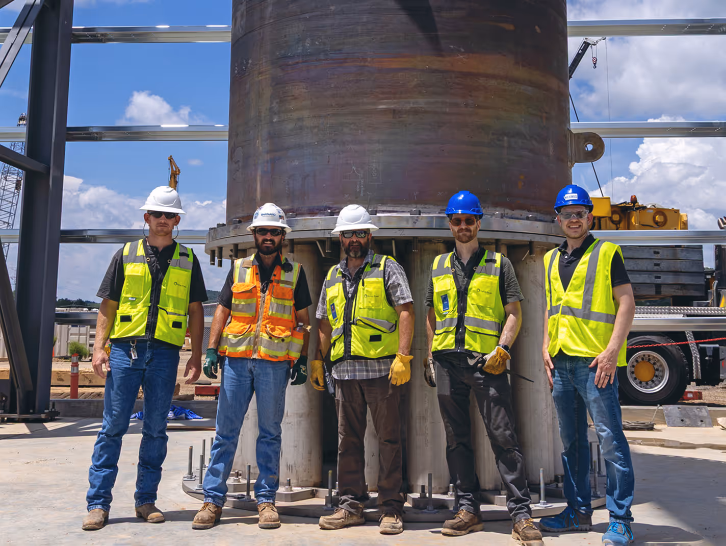 Team members beside vessel