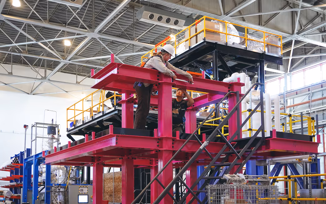 Worker observing construction in manufacturing facility