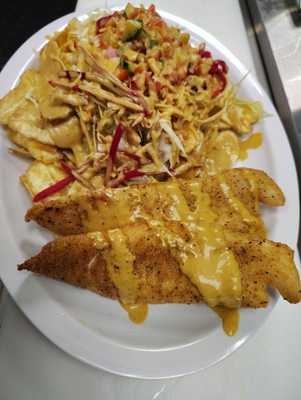 A plate of food with fish and a salad.