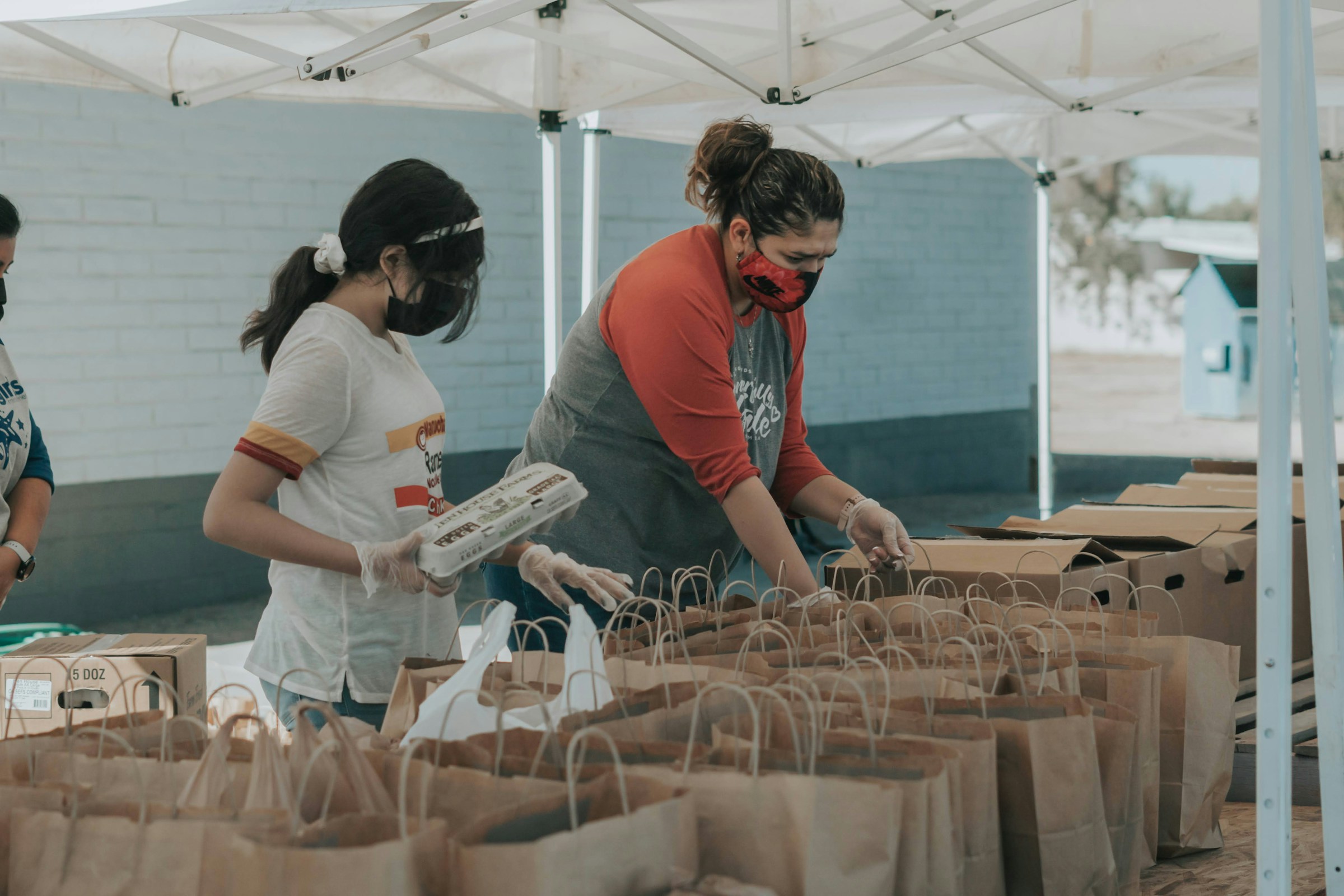 Community nonprofit volunteers organizing food distribution at local outreach event
