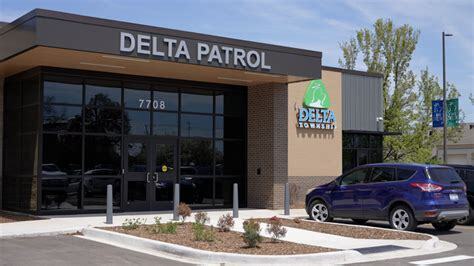 The Delta Patrol building with a glass entrance, Delta Township logo, and a parked blue SUV in front.