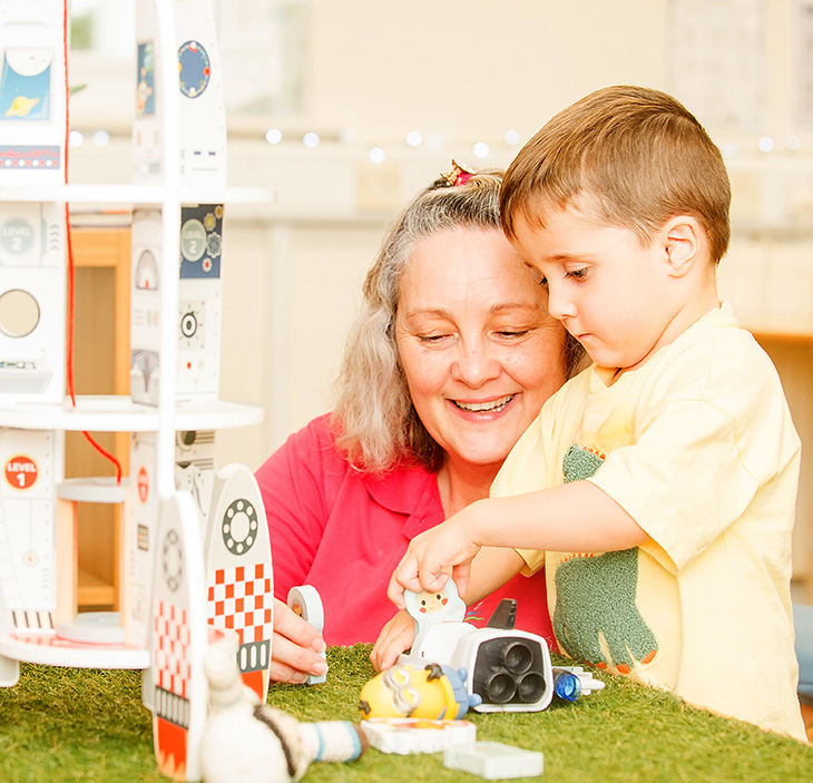 Toddler, learning through play with his teacher