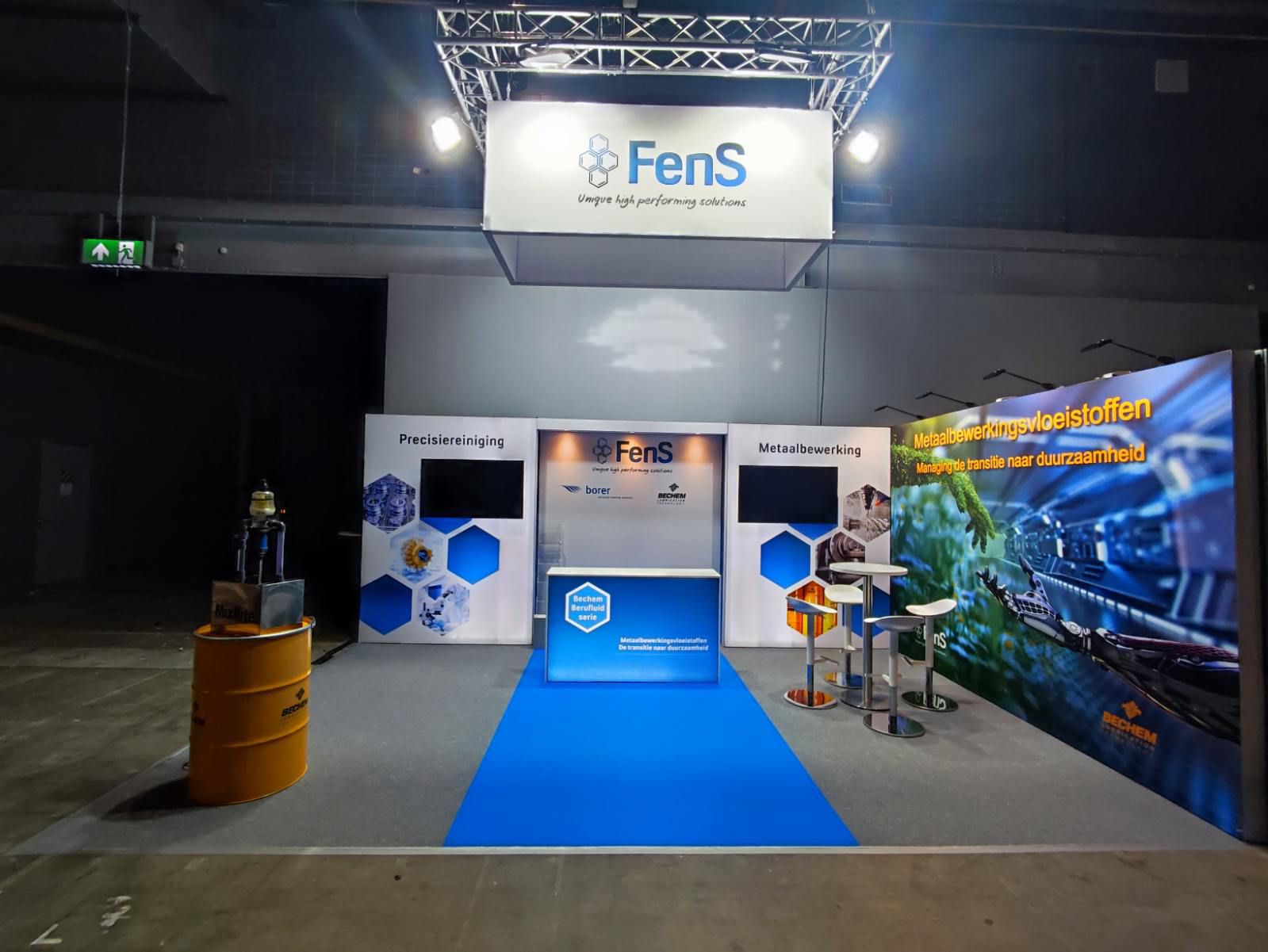 Exhibition stand with suspended branding, digital displays and product demonstration area