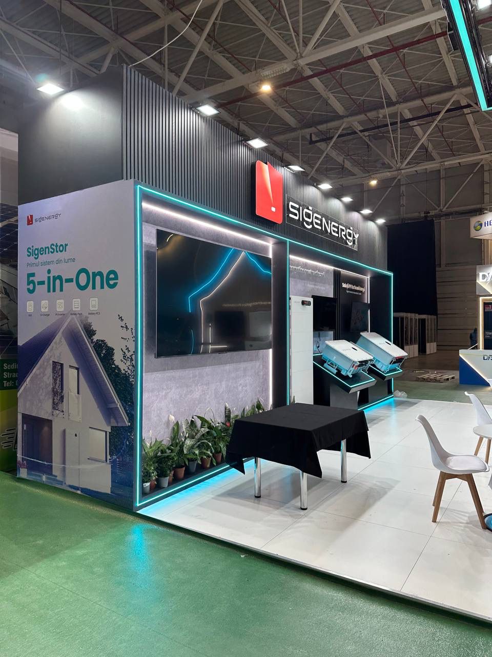 Exhibition stand with illuminated product displays, digital screen and reception area