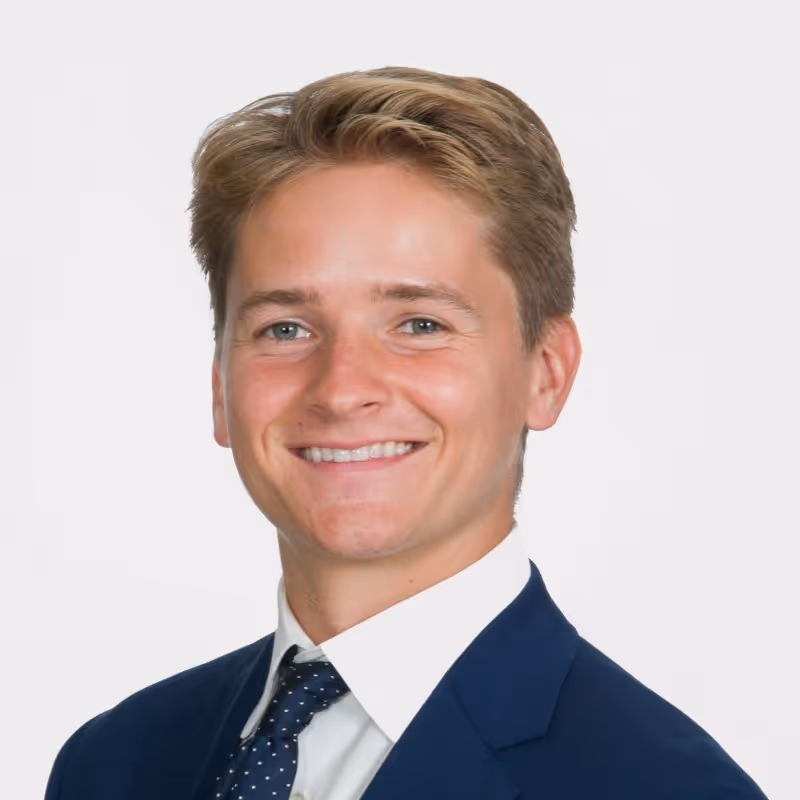 A person in formal attire, smiling warmly against a white background, with short light brown hair. Previously with Alphasites, placed with Profound.