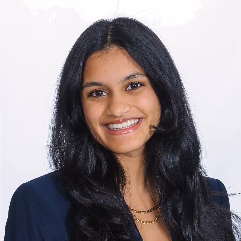 Professional sales woman with long black hair in a professional headshot. She wears a dark blazer, exuding confidence and warmth. Previously with AlphaSites, placed with AVOCA. Text overlay reads “Education: UNC Chapel Hill, Past Company: AlphaSites.