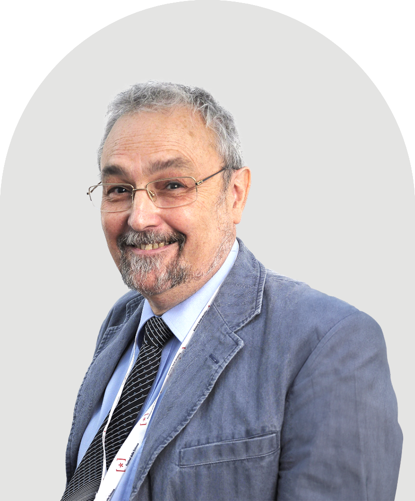 Robin Dunbar wearing glasses wearing a blue jacket, light blue shirt, and striped tie.