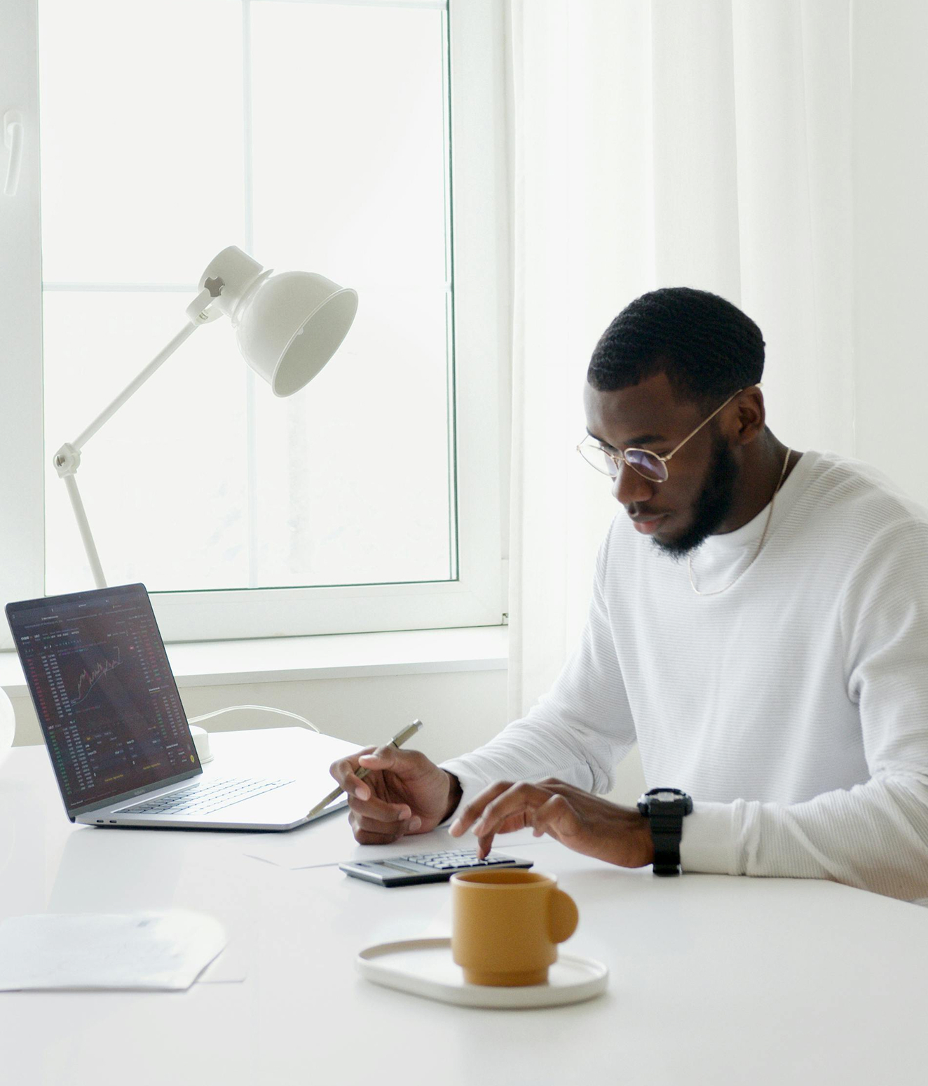 A person working at a laptop in a bright room