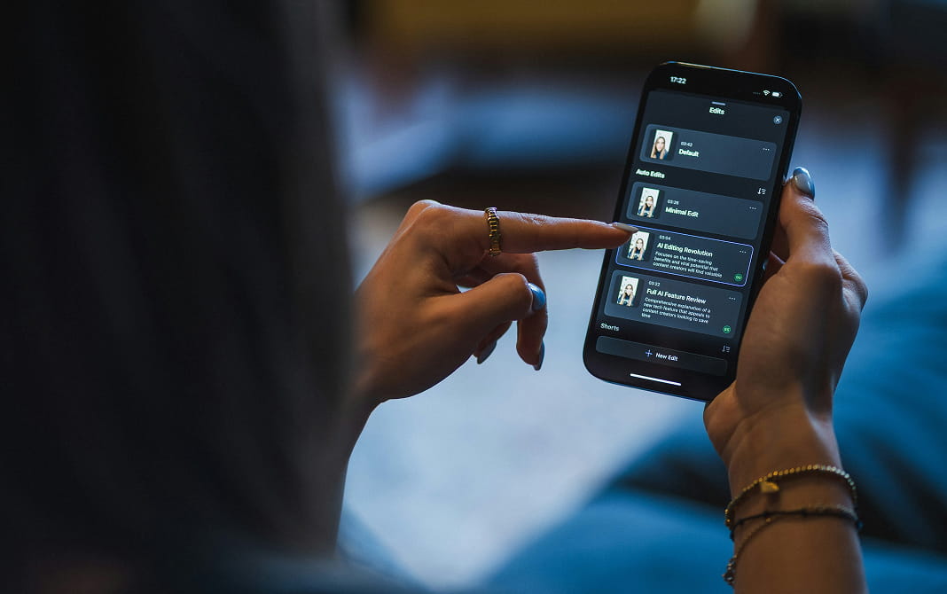 A person comparing information on a phone and laptop