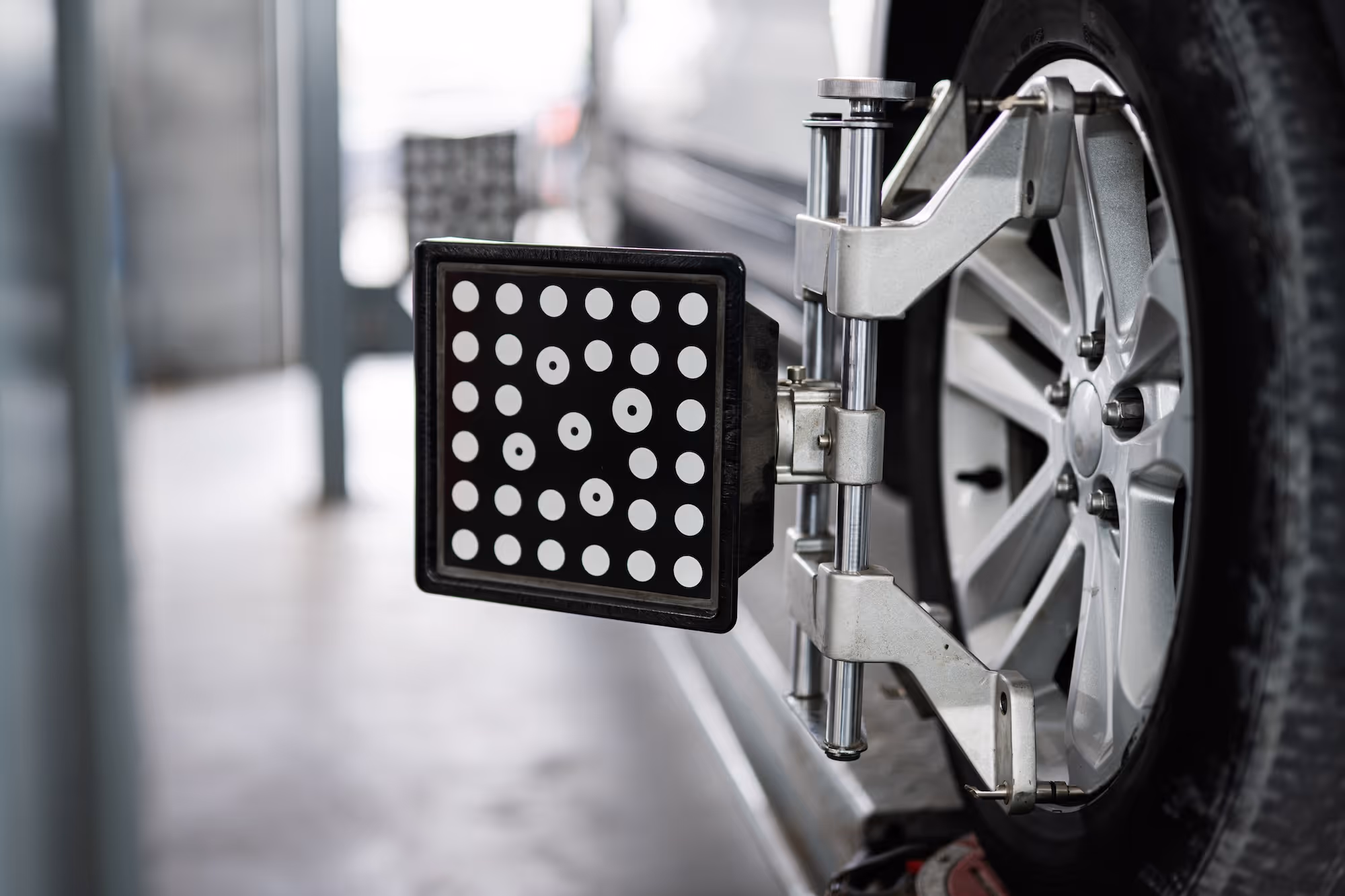 Wheel alignment tool attached to the hubcap of a car.