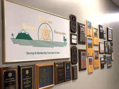RSA office wall displaying the Riverside Sheriff's Association banner and numerous award plaques.