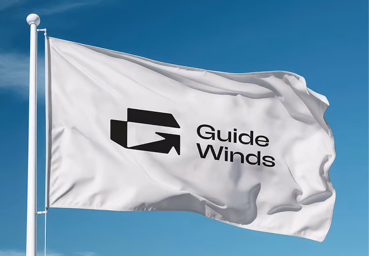 White flag waving on a pole against a blue sky, featuring a black logo with a stylized arrow and the text 'Guide Winds'.
