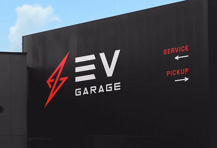 Black building wall with a red lightning bolt logo next to white text reading 'EV GARAGE' and red directional signs indicating 'SERVICE' to the left and 'PICKUP' to the right.