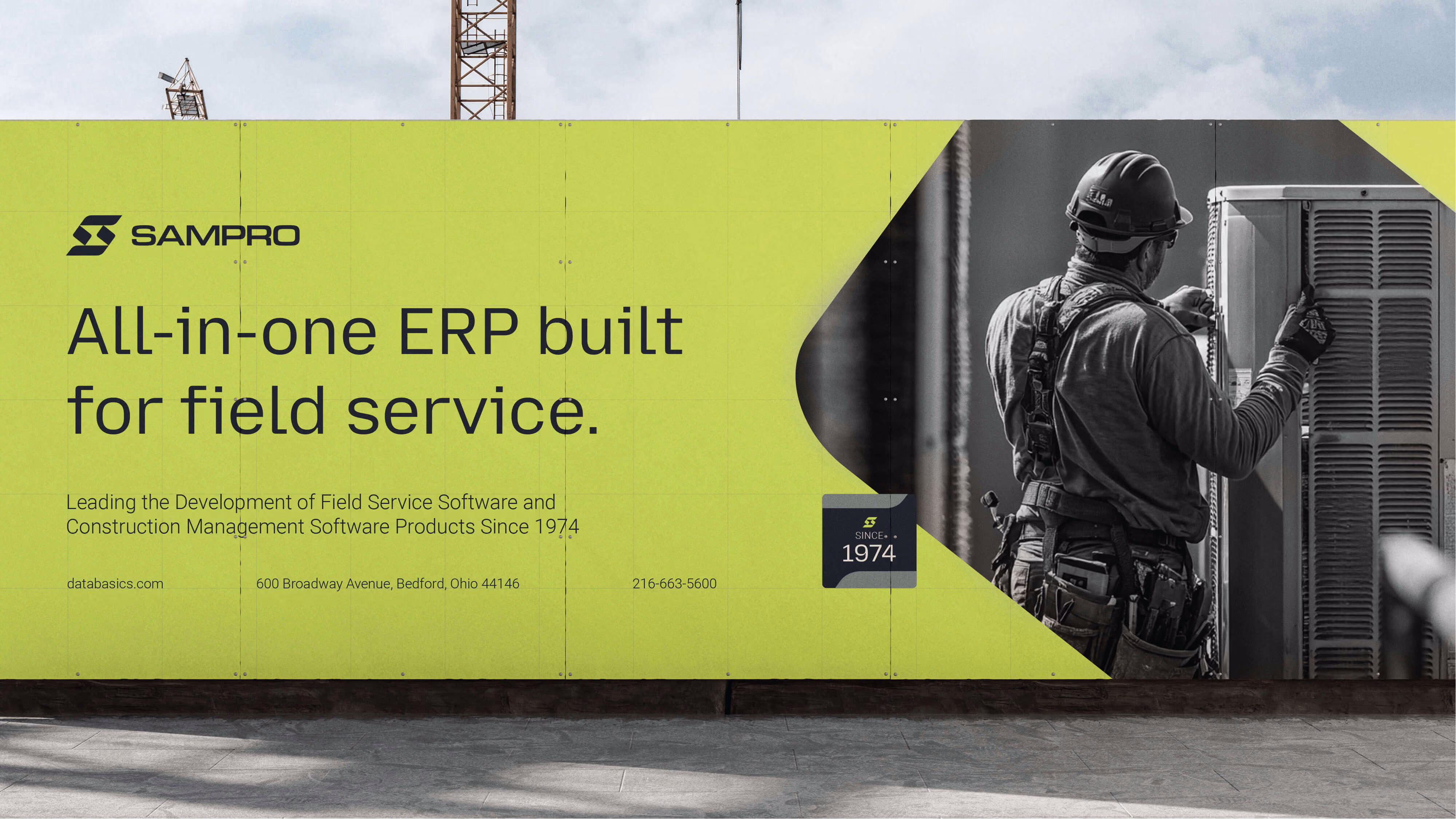 Outdoor advertising banner on a construction site featuring SamPro, promoting an all-in-one ERP built for field service, with a black-and-white image of a worker inspecting an air conditioning unit on the right side.