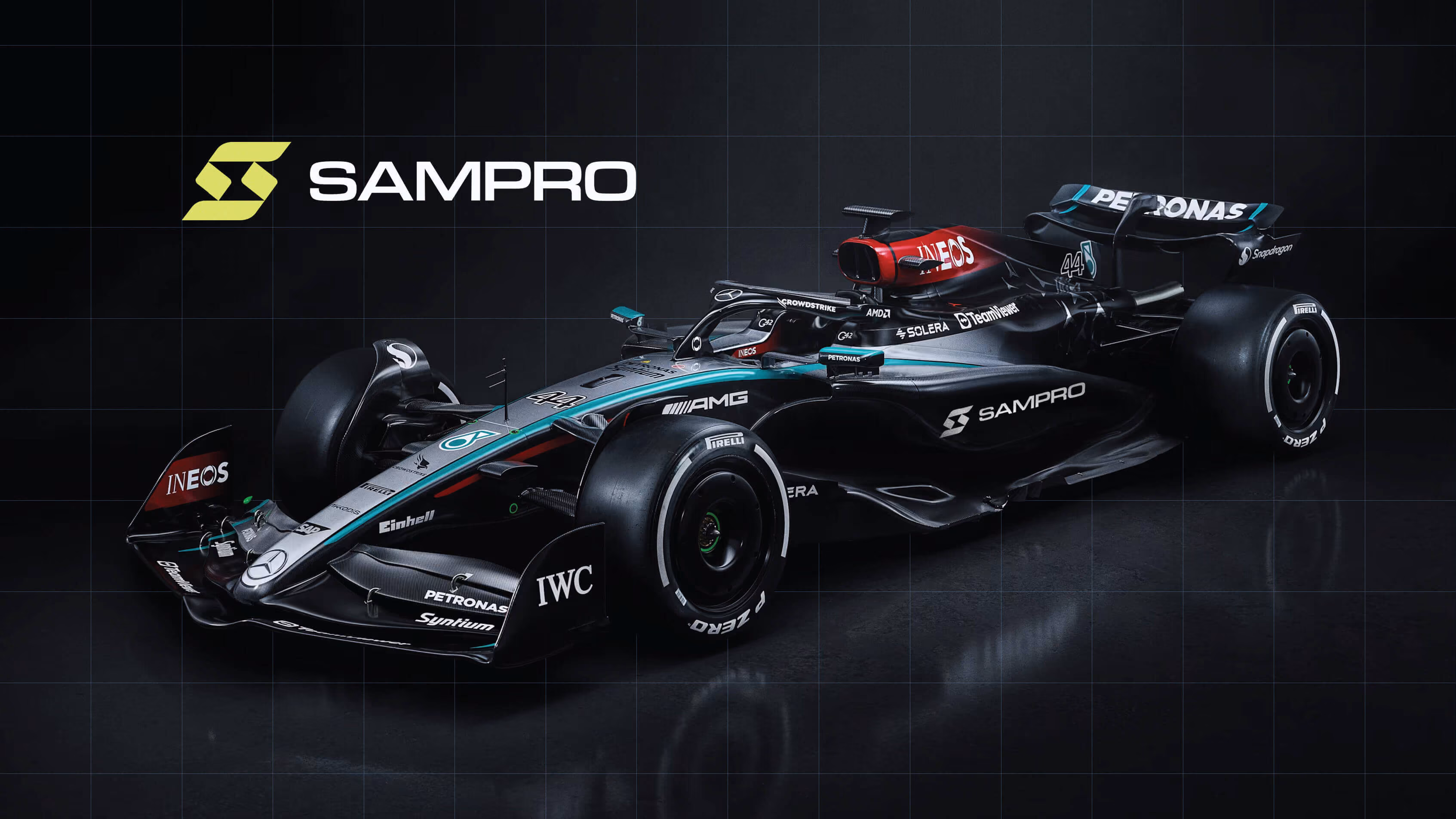 Black and teal Formula 1 race car with prominent sponsor logos including SAMPRO, PETRONAS, INEOS, and AMG, displayed on a dark reflective surface with a grid pattern background.