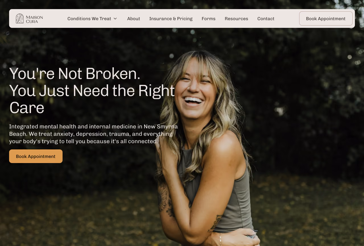 Website header with menu options and a smiling woman with blonde hair wearing a sleeveless top in an outdoor setting, featuring text about integrated mental health and internal medicine care in New Smyrna Beach.
