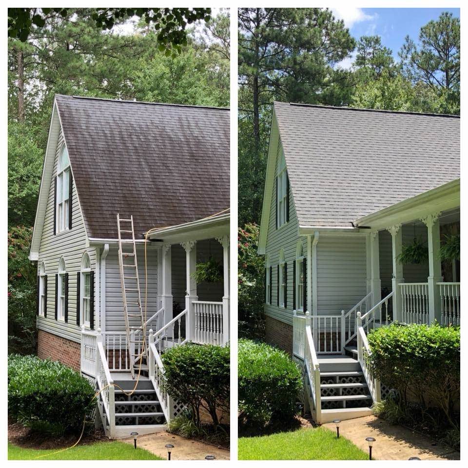 Side-by-side comparison of a house's roof before and after cleaning, showing a dark stained roof on the left and a clean, light gray roof on the right.