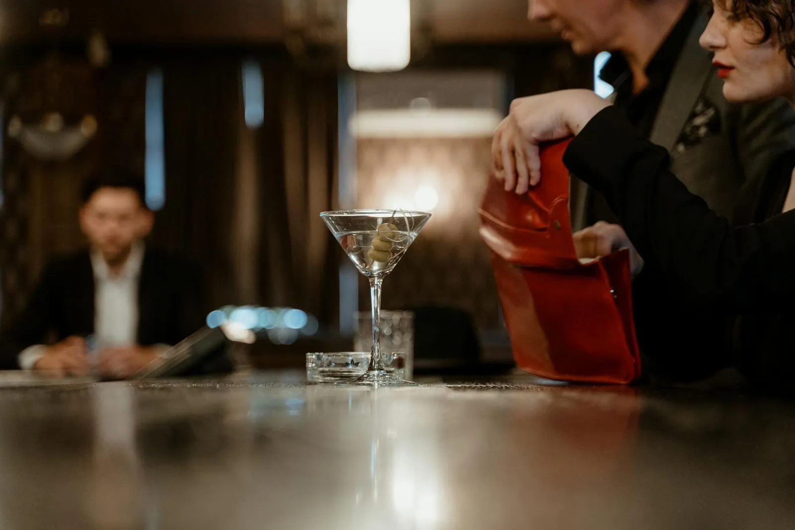 A man and a woman sitting at a bar.