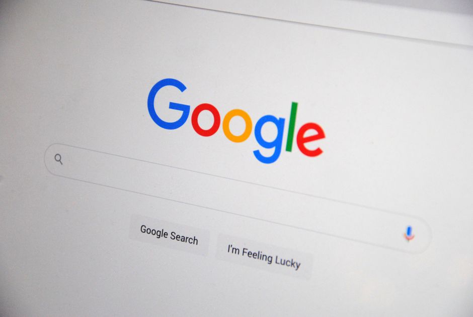Close-up of the Google homepage on a screen, showing the Google logo, an empty search box and the Google Search and I'm Feeling Lucky buttons