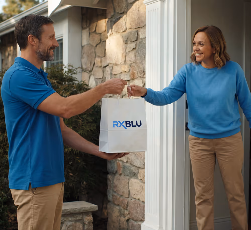 A man delivering a RXBLU medicine bag to a woman