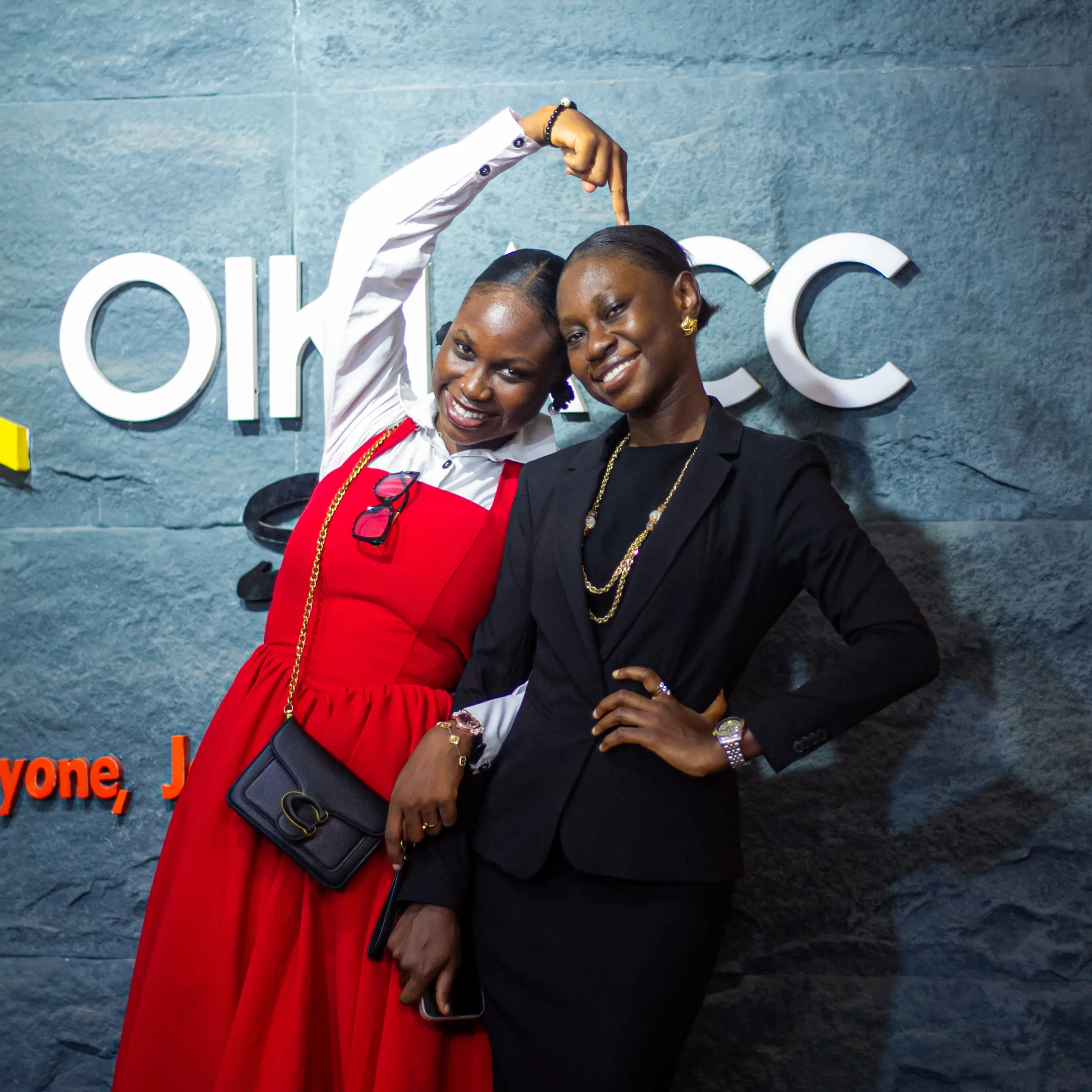 Man in a pinstripe suit singing into a microphone with colorful blurred lights in the background.