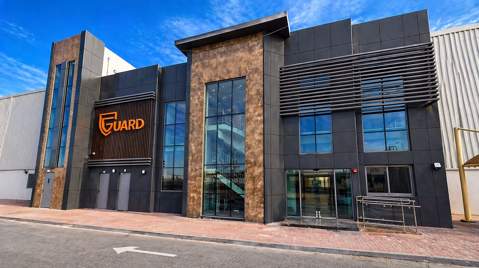 Modern fire fighting equipment manufacturing facility building exterior with contemporary industrial architecture and GUARD branding in UAE industrial zone