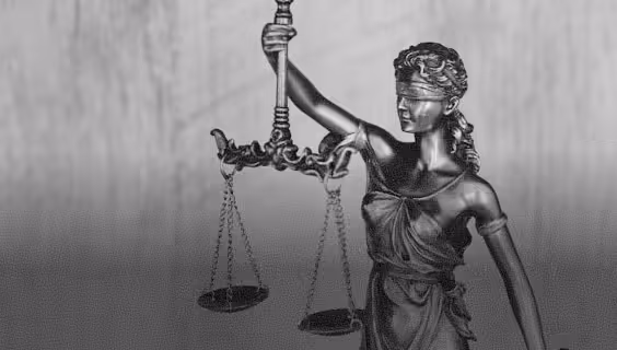 Bronze statue of Lady Justice blindfolded, holding a balanced scale.
