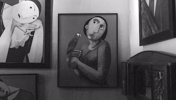 Surreal paintings displayed on a wall, featuring human-like figures with exaggerated eyes and a person holding a bird.
