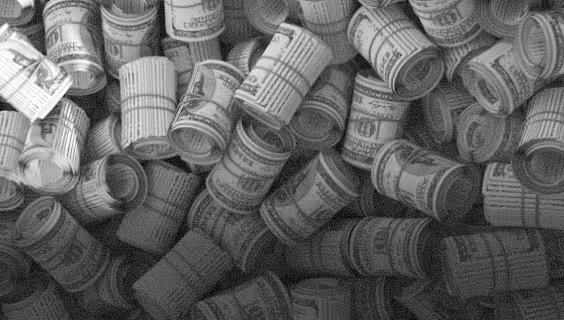 Numerous rolled-up sheets, resembling printed booklets or tickets, scattered closely together.