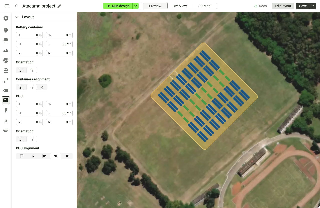 Aerial view of a solar panel layout design on a grassy field with trees around and a running track in the lower right corner.