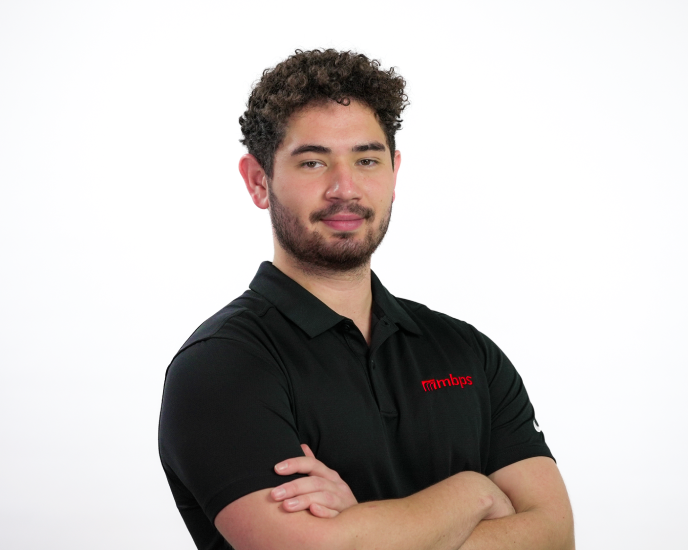 MBPS managed IT support technician in branded polo shirt posing professionally with arms crossed