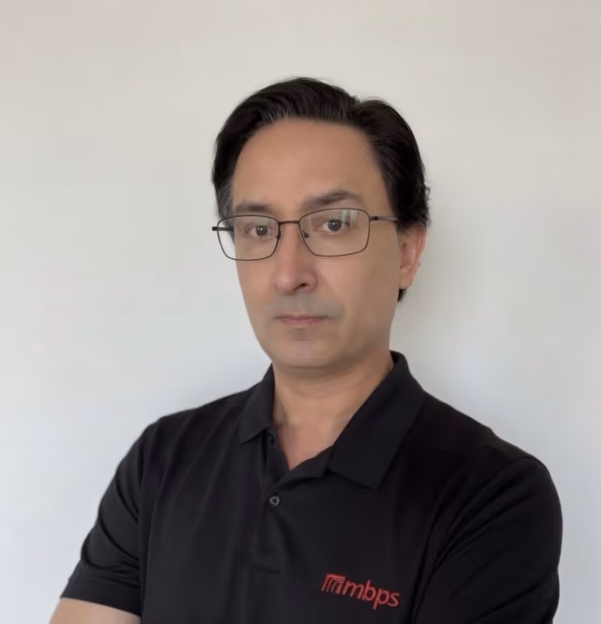 Man in MBPS branded black polo shirt posing professionally for Phoenix managed IT services provider headshot