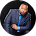 Man in suit speaking or presenting, likely at a business or IT conference event