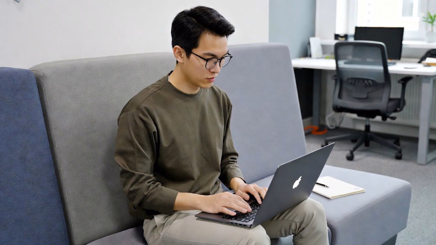 LOUNGE AREA LAPTOP An IT professional one person working on a laptop in a ca