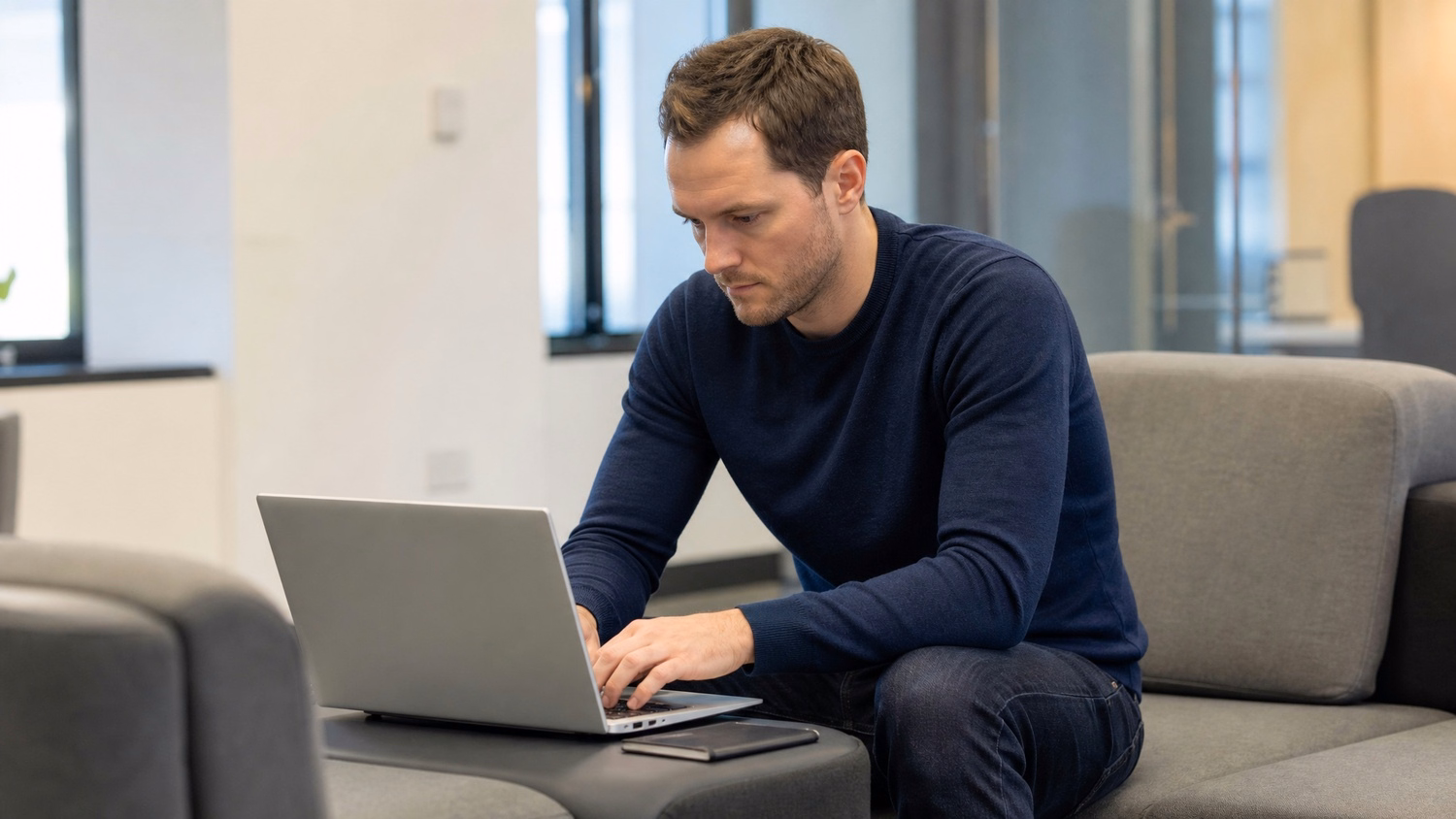 LOUNGE AREA LAPTOP An IT professional one person working on a laptop in a ca