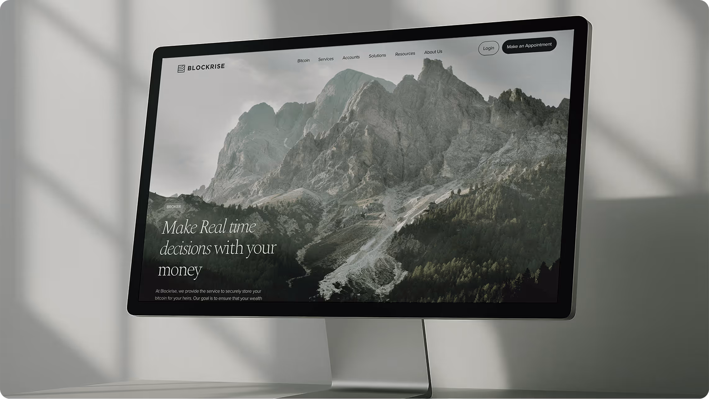 Computer monitor displaying Blockrise website with mountain background and text about making real-time money decisions.