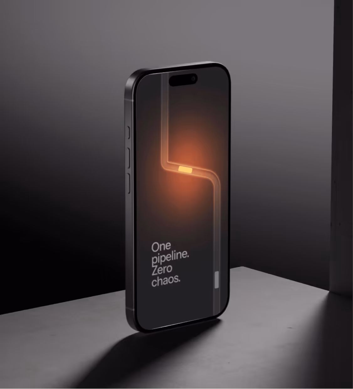 Black smartphone standing on a gray surface with a glowing orange pipeline graphic and text that reads 'One pipeline. Zero chaos.'
