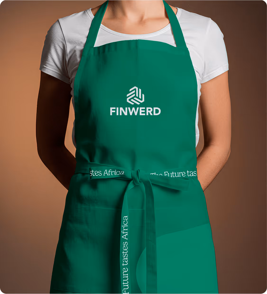 Person wearing a green apron with the word FINWERD and a logo, and a tied strap that reads 'Future tastes Africa.'